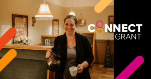 A smiling woman holds a coffee carafe and a mug in a cafe. The text "connect grant" is on the right.
