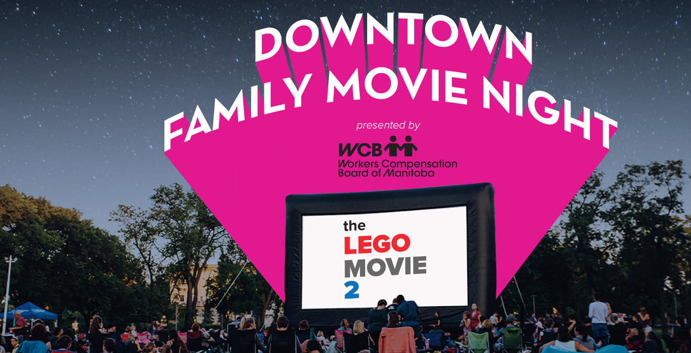 Downtown family movie night, people sitting on the grass in front of a large outdoor movie screen promoting the Lego Movie 2.